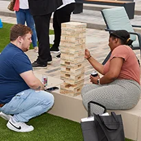 People playing Big Jenga in Courtyard at District 121